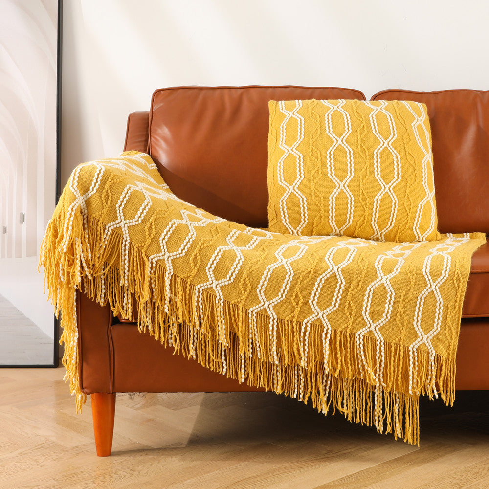 Real sofa styled with a bohemian knitted throw blanket in a living room, from EverNest Living's home collection